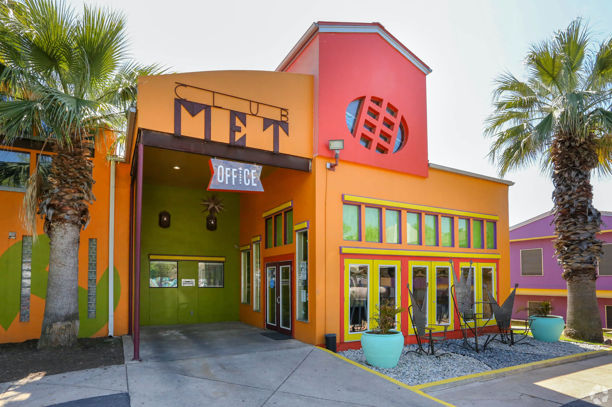 Front view of The Metropolis Apartments with office sign