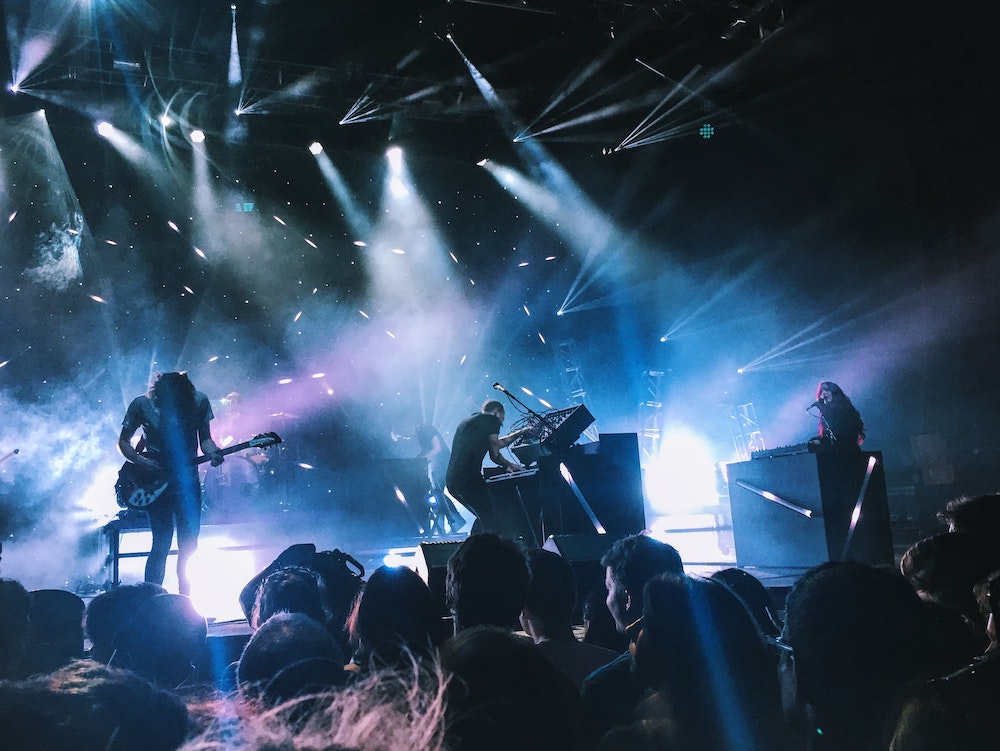 A live concert with bright lights and a band on stage