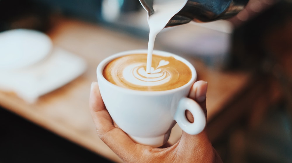 A barista pouring wonderful latte art