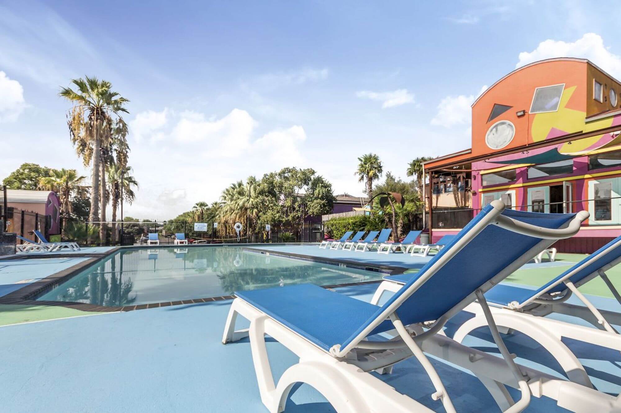 The bright blue pool at The Metropolis Apartments