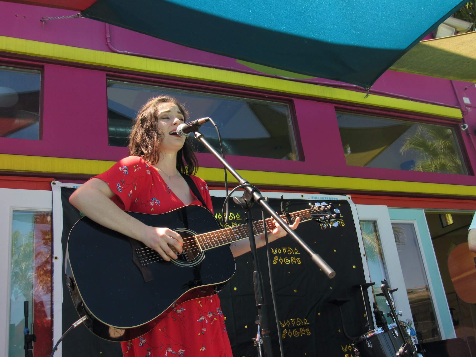 Woman singing at at live stage at The Metropolis Apartments